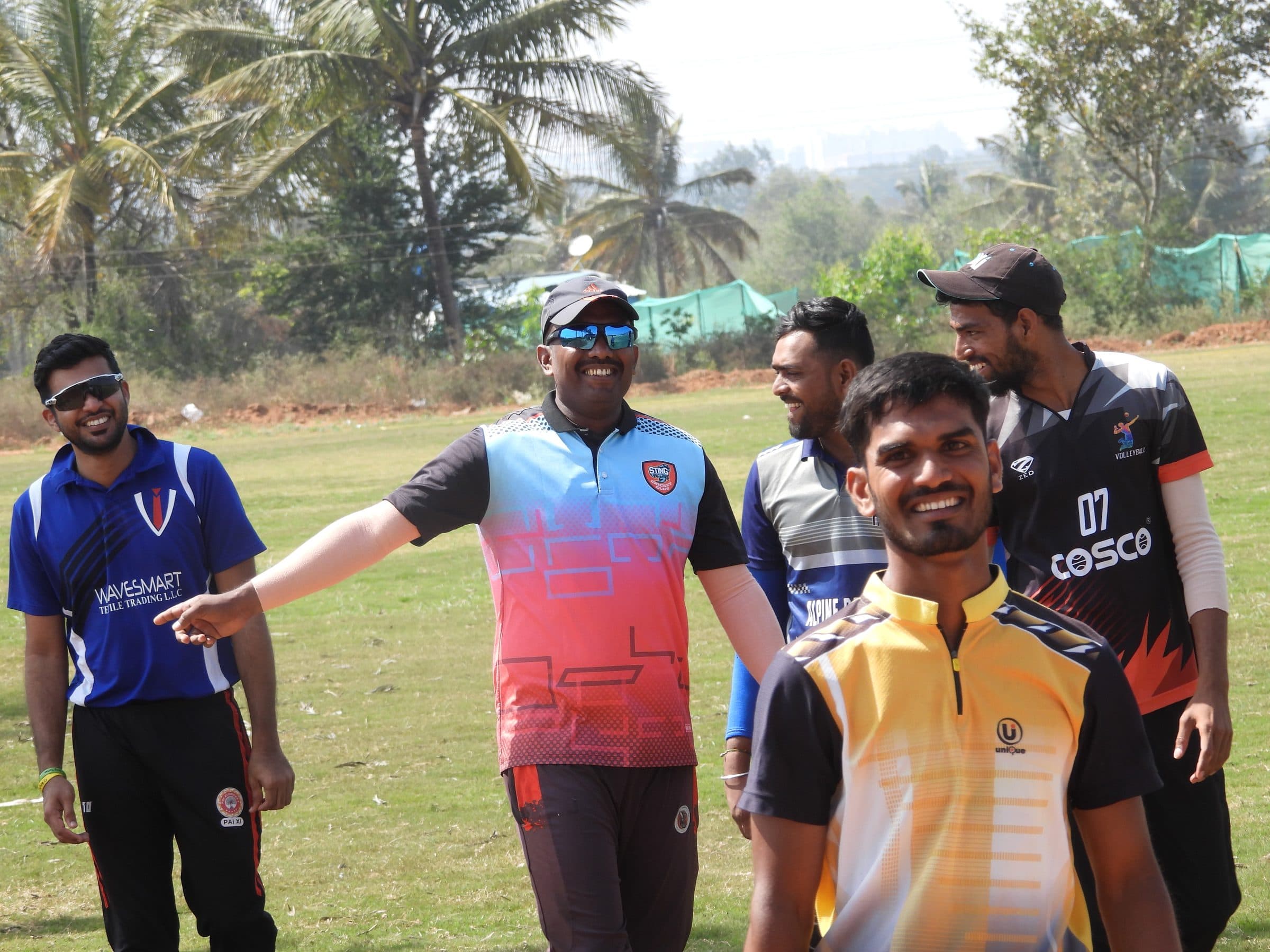 Axi Club players sharing a laugh on the outfield between innings